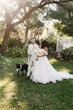 Bride wearing Lettie by Rebecca Ingram walking with her husband and dog