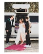 Bride wearing Darius wedding dress by Maggie Sottero getting out of a car