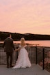 Bride wearing Laila wedding dress by Maggie Sottero standing with her husband