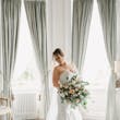 Bride Wearing Modern Wedding Dress Called Marilyn By Sottero And Midgley Holding Pastel Rose Bouquet
