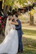 Groom Kissing Bride at Fall Wedding Wearing Wedding Dress Called Valona by Sottero and Midgley.