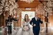 Bride wearing Stevie wedding gown by Maggie Sottero walking down the aisle