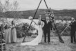 Bride and groom cheering with hands in the air as they are pronounced husband and wife.