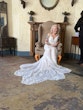 Bride Wearing Beaded Lace Wedding Dress Called Franklynn By Maggie Sottero Sitting In A Chair