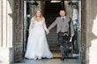 Bride wearing Iris wedding dress by Rebecca Ingram exiting with her husband