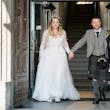 Bride wearing Iris wedding dress by Rebecca Ingram exiting with her husband