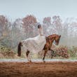 Bride wearing Drita wedding dress by Maggie Sottero riding a horse
