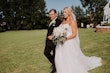 Groom With Bride Wearing A-Line Lace Wedding Dress Marisol By Rebecca Ingram