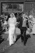 Bride wearing Yates wedding dress by Maggie Sottero with flower petals being thrown