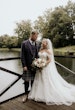 Bride wearing Rousseau wedding dress by Maggie Sottero with her husband