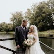 Bride wearing Rousseau wedding dress by Maggie Sottero with her husband