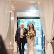 Bride wearing Tuscany Lynette being walked down the aisle by her father