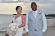 Bride wearing Franklynn by Sottero and Midgley with her husband on the beach