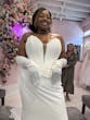 Bride Wearing Deep V-Neck Wedding Dress Called Jace By Maggie Sottero Trying On In A Boutique