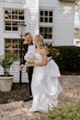 Groom Walking With Bride In A White Strapless Wedding Dress Named Mitchell By Maggie Sottero