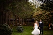 Bride wearing Holden wedding dress by Sottero and Midgley holding hands with the groom