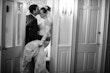 Bride wearing Kern by Maggie Sottero being kissed in a doorway by her husband