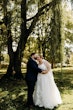 Bride wearing Pia wedding dress by Maggie Sottero kissed by her husband