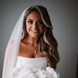 Bride wearing Holden wedding dress by Sottero and Midgley holding her bouquet