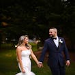 Bride wearing Holden wedding dress by Sottero and Midgley holding hands with her husband