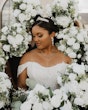 Bride Wearing Sparkly Ballgown Wedding Dress Called Zartasha By Sottero and Midgley Surrounded By White Flowers