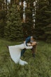 Groom dipping bride in the outdoors. Bride wearing boots with her wedding dress called Tina Dawn.