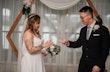 Bride wearing Jessica by Maggie Sottero playing rock paper scissors with her husband