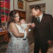 Bride Wearing Lace Wedding Dress Called Ladonna By Maggie Sottero Holding Her Baby With Groom