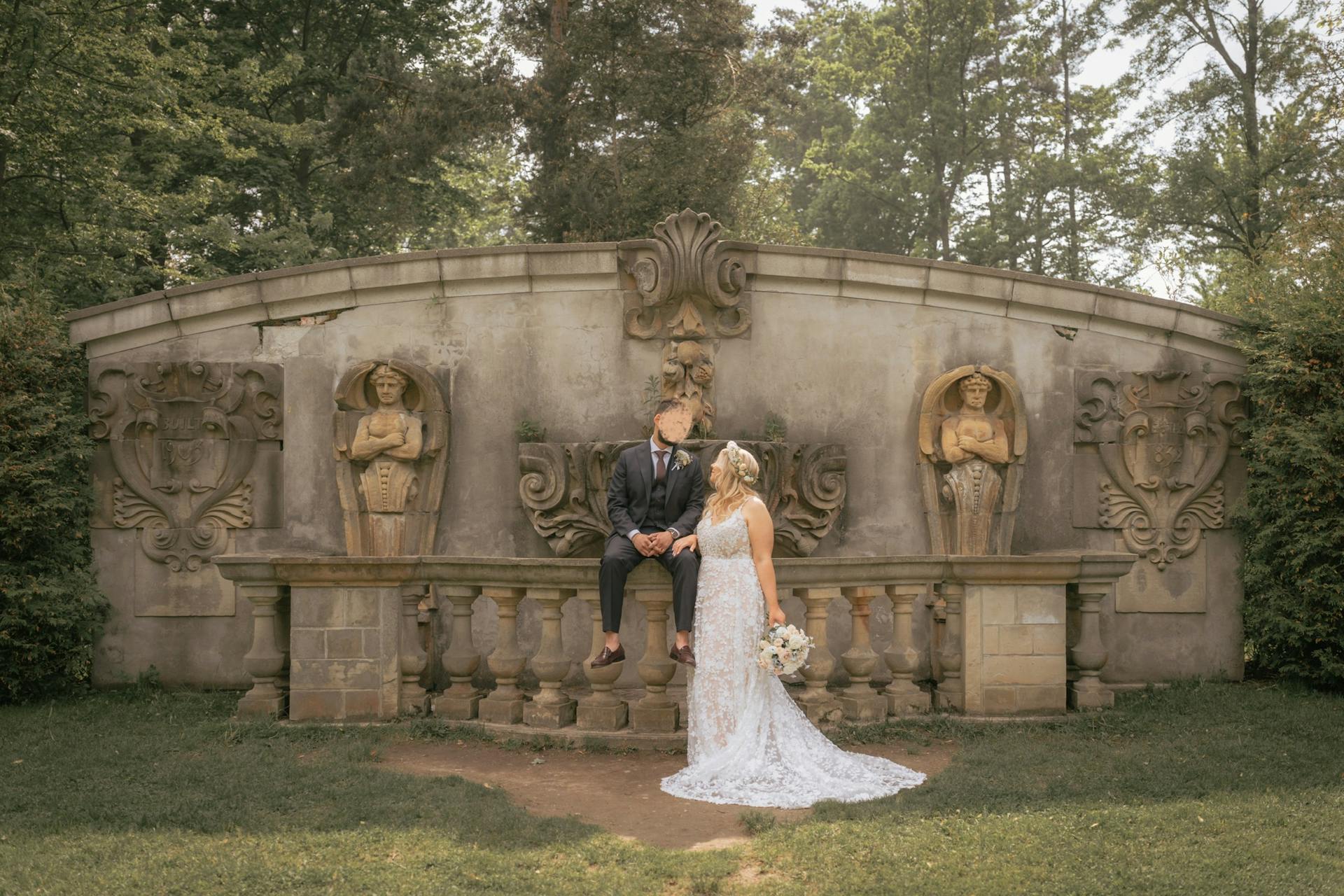 Bride Wearing Lace Wedding Dress Called Ladonna By Maggie Sottero With Groom Next To A Bridge With Statues