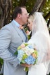 Bride wearing Saratoga by Maggie Sottero being kissed by her husband