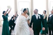 Bride wearing Ekaterina by Maggie Sottero leaving their ceremony with her husband