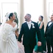 Bride wearing Ekaterina by Maggie Sottero leaving their ceremony with her husband