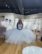 Bride-to-be Trying On Modern Square Neck Ball Gown With Simple Tulle Skirt Called Vivien By Rebecca Ingram