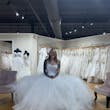 Bride-to-be Trying On Modern Square Neck Ball Gown With Simple Tulle Skirt Called Vivien By Rebecca Ingram