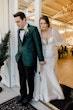 Groom And Bride Share First Touch. Bride Wearing Mikado Mermaid Dress With Plunging Neckline Called Pippa By Rebecca Ingram