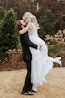 Groom Kissing Bride Wearing Plunging Lace Illusion Wedding Dress Called Raelynn By Rebecca Ingram