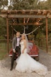 Bride Wearing Pink Lace Mermaid Wedding Dress Called Kenleigh By Sottero And Midgley With Groom Next To Vintage Car