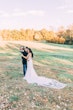 Bride Wearing Crepe Sheath Wedding Dress Called Alda By Rebecca Ingram Hugging Groom