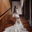 Bride wearing Ryker wedding dress by Sottero and Midgley walking up stairs