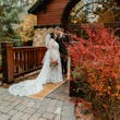 Bride Wearing Lace Wedding Dress Called Ladonna By Maggie Sottero Kissing Groom In Front Of A Cabin