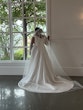 Real Bride Looking Out Window In a White Wedding Dress Named Darius By Maggie Sottero With Veil