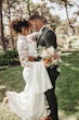 Bride Wearing Crepe And Lace Bridal Dress Called Dionne By Rebecca Ingram With Groom Looking At Each Other