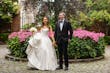 Bride Wearing Simple Ballgown Wedding Dress Called Fortune By Maggie Sottero With Groom Next To Pink Flowers