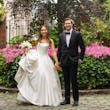 Bride Wearing Simple Ballgown Wedding Dress Called Fortune By Maggie Sottero With Groom Next To Pink Flowers