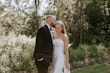 Groom Kissing Bride In A White Strapless Wedding Dress Named Mitchell By Maggie Sottero