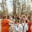 Bride Wearing Lace Wedding Dress Called Ladonna By Maggie Sottero Kissing Groom With Family Celebrating