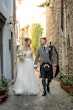 Bride wearing Iris wedding dress by Rebecca Ingram with her husband