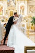 Bride Wearing Lace Princess Wedding Dress Called Norvinia By Sottero And Midgley Kissing Groom In A Chapel