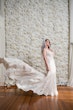 Bride wearing Bailey by Sottero and Midgley in front of a flower wall