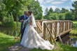 Bride with groom wearing a lace and tulle ballgown wedding dress